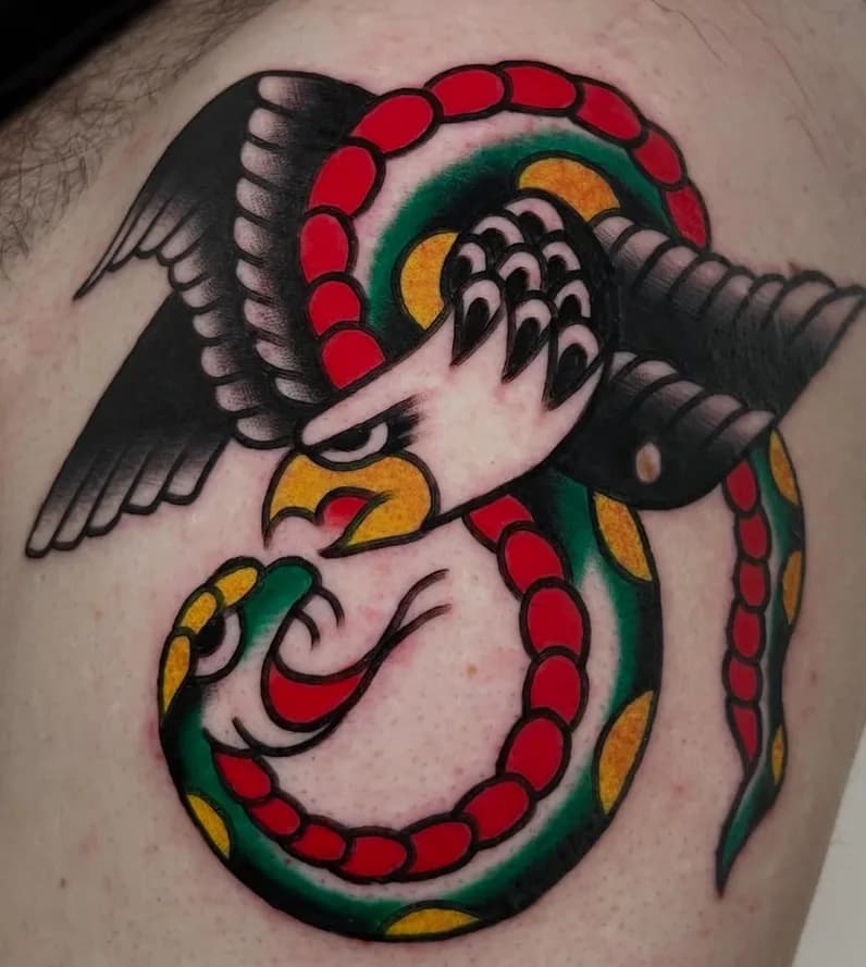 Traditional colorful eagle fighting a snake tattoo, on the shoulder